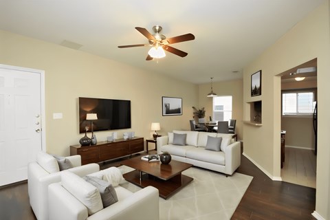 a living room with white couches and a coffee table